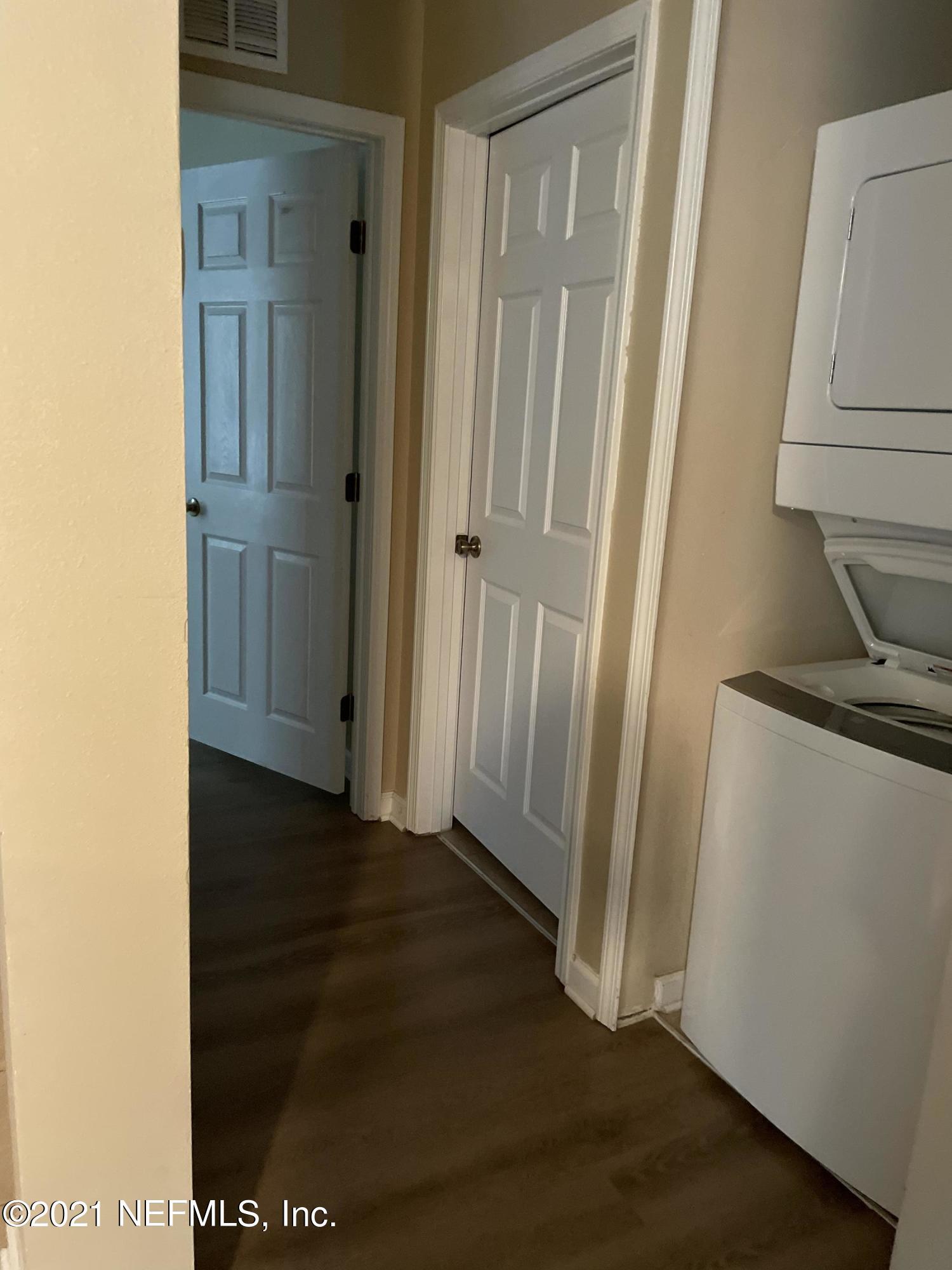 2200 Marsh Hawk Lane, Unit 101 Fleming Island, FL 32003 - Photo 3 of 18 a view of a hallway with wooden floor