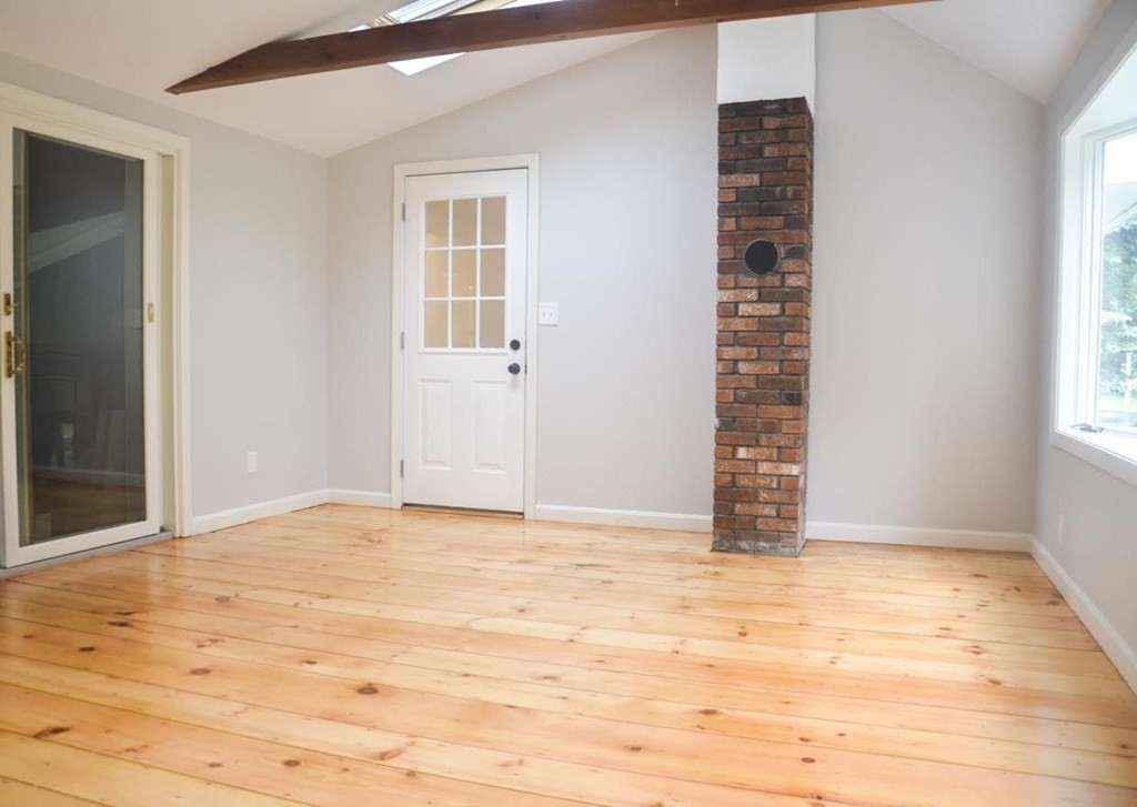 198 Cedar Street Hanover, MA 02339 - Photo 4 of 12 a view of an empty room with wooden floor and a window