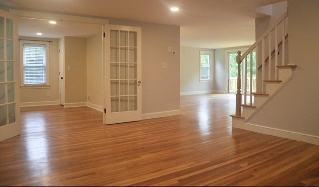 198 Cedar Street Hanover, MA 02339 - Photo 6 of 12 a view of an empty room with wooden floor and a window