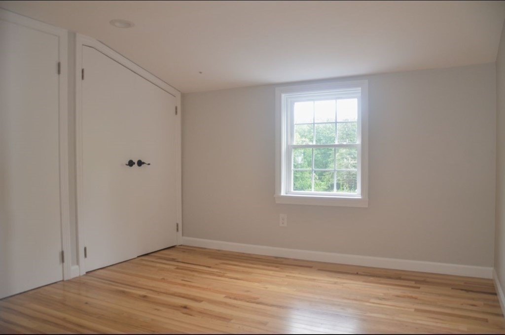 198 Cedar Street Hanover, MA 02339 - Photo 8 of 12 a view of empty room with wooden floor and fan