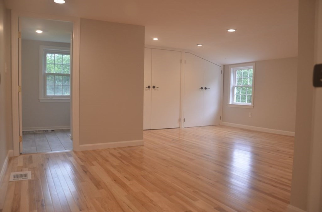 198 Cedar Street Hanover, MA 02339 - Photo 9 of 12 an empty room with wooden floor and windows