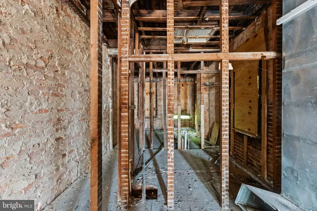 a view of a balcony with wooden floor and a potted plant