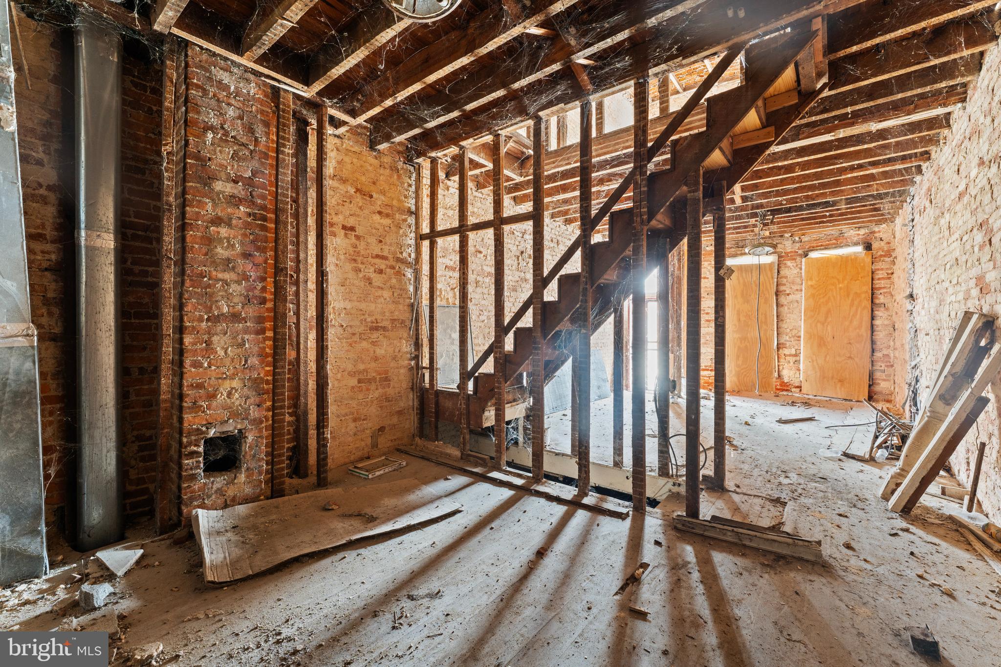 809 Appleton Street Baltimore, MD 21217 - Photo 7 of 16 a view of an empty room with wooden floor and windows
