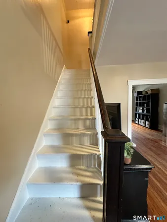 a view of entryway and hall with wooden floor