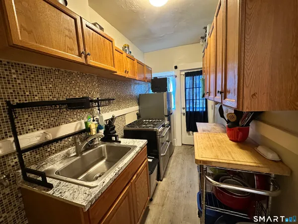 a kitchen that has a sink and a stove