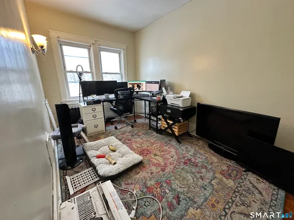 a living room with furniture and next to a window