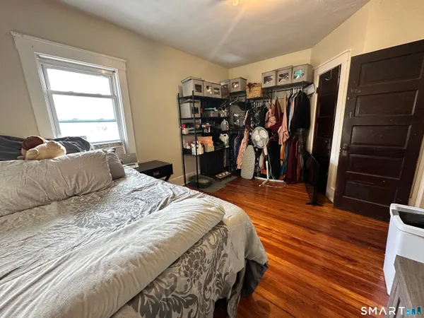 a bedroom with a bed closet and a window
