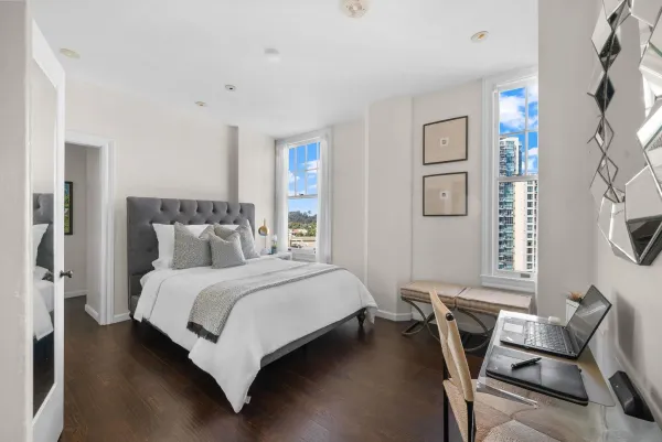 a bedroom with a bed and wooden floor