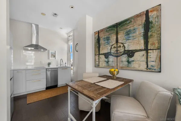a kitchen with a table chairs and a refrigerator