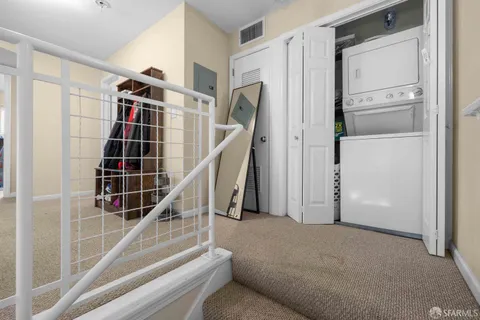 a view of hallway with stairs and wooden floor