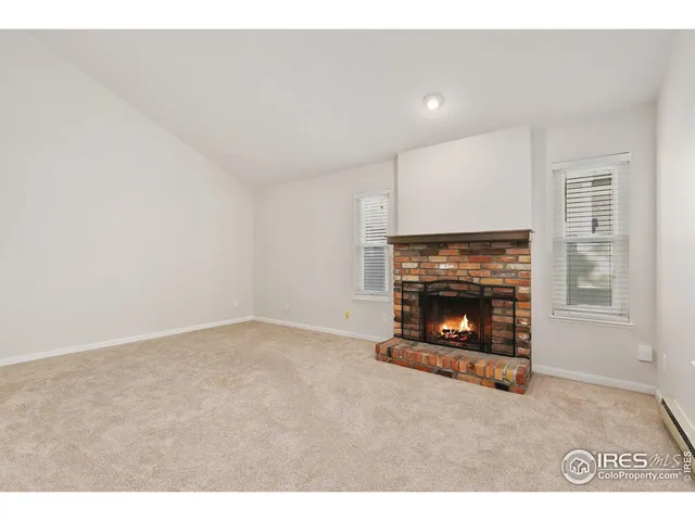 a view of an empty room with a fireplace
