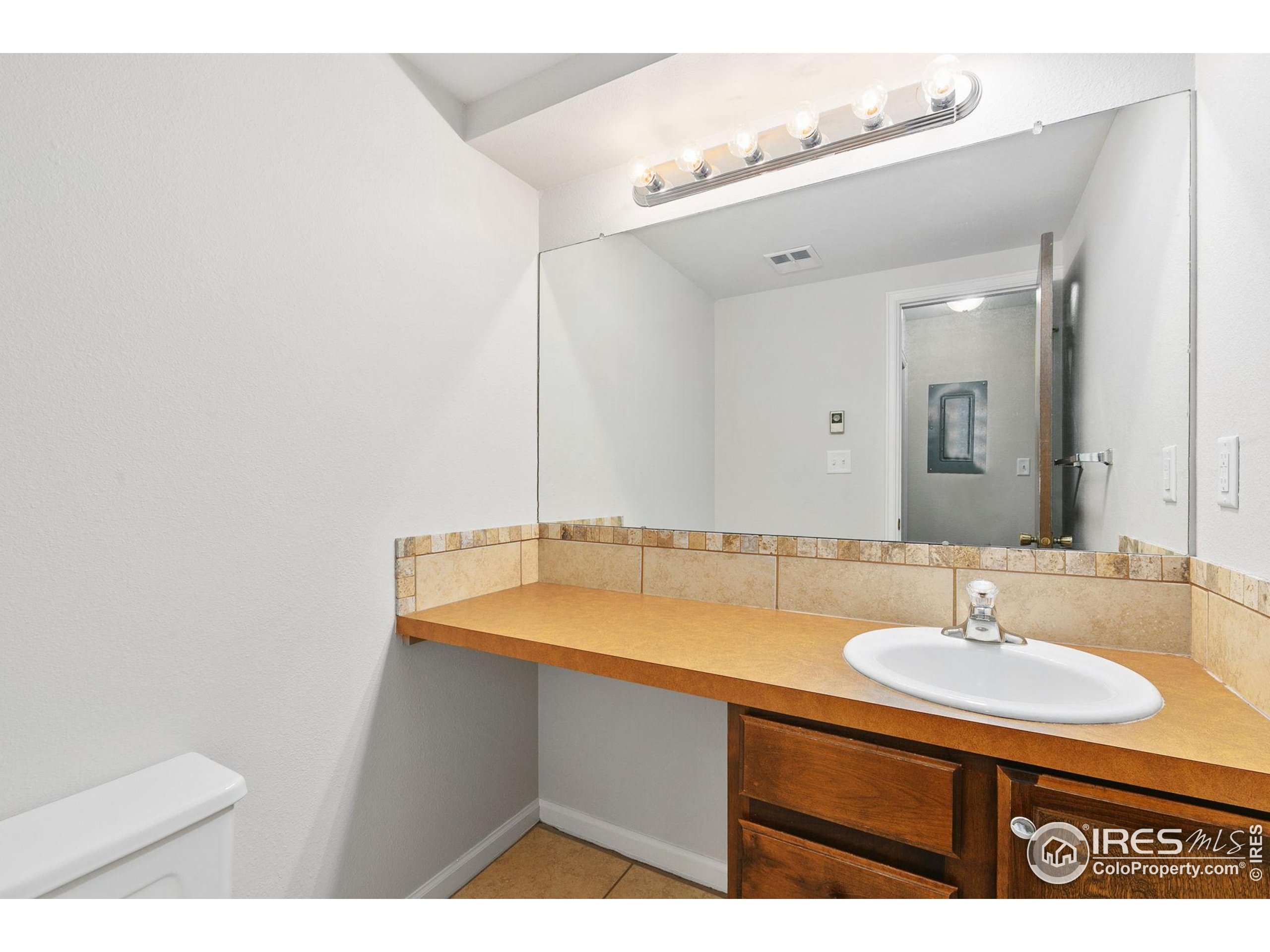 1741 Brookhaven Circle East, Unit D Fort Collins, CO 80525 - Photo 14 of 30 a bathroom with a sink and a mirror