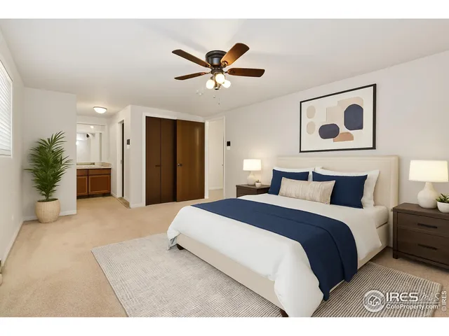 a bedroom with a large bed and a chandelier