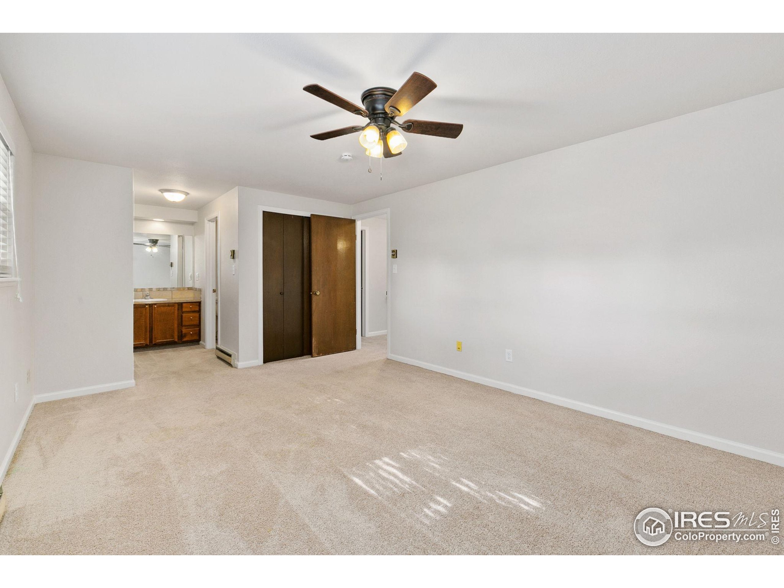 1741 Brookhaven Circle East, Unit D Fort Collins, CO 80525 - Photo 18 of 30 a view of a livingroom with a ceiling fan and window