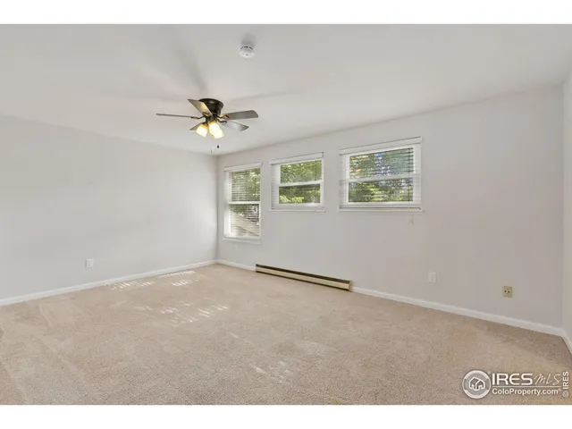 a view of an empty room with a ceiling fan