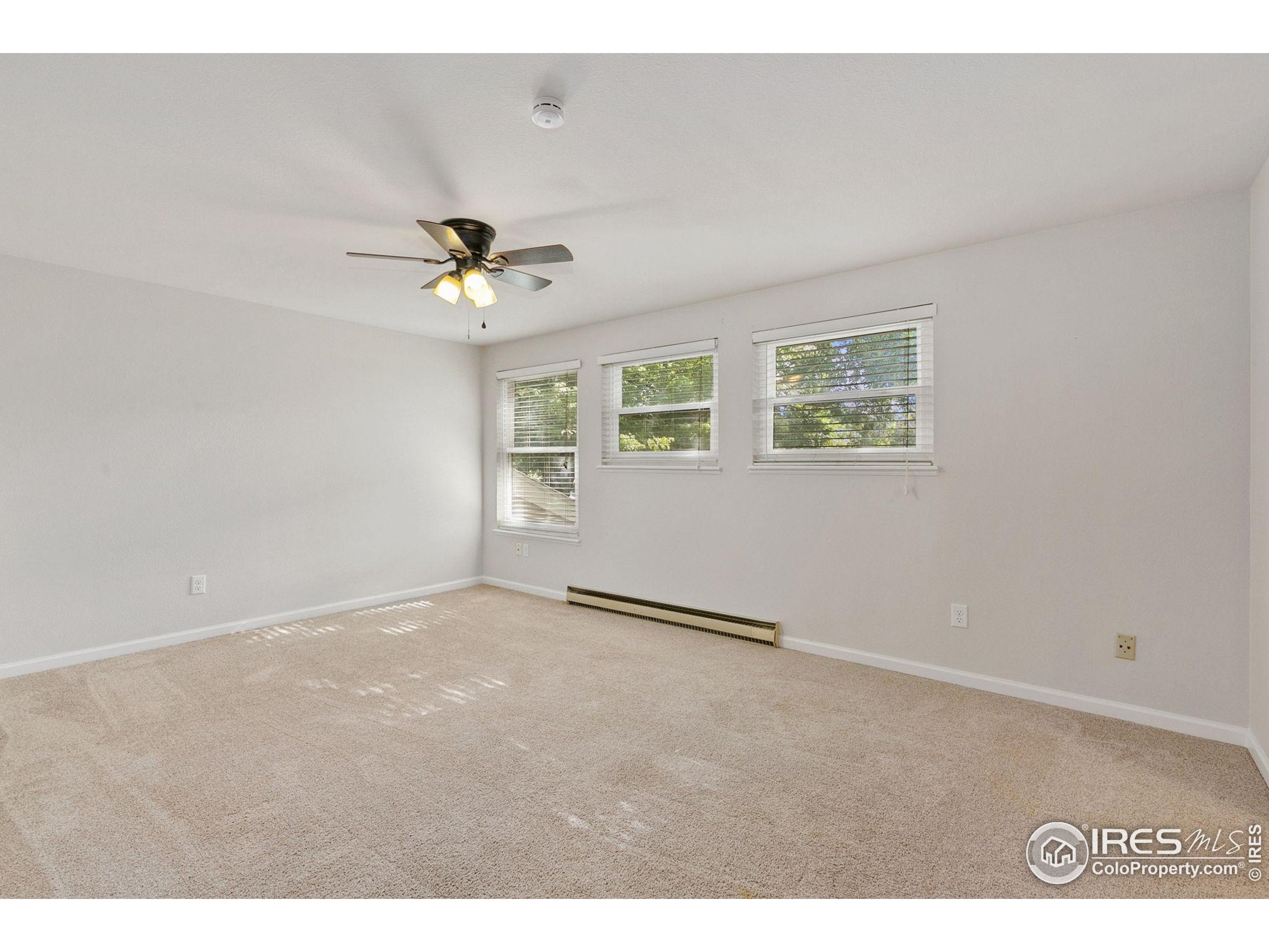 1741 Brookhaven Circle East, Unit D Fort Collins, CO 80525 - Photo 19 of 30 a view of an empty room with a ceiling fan