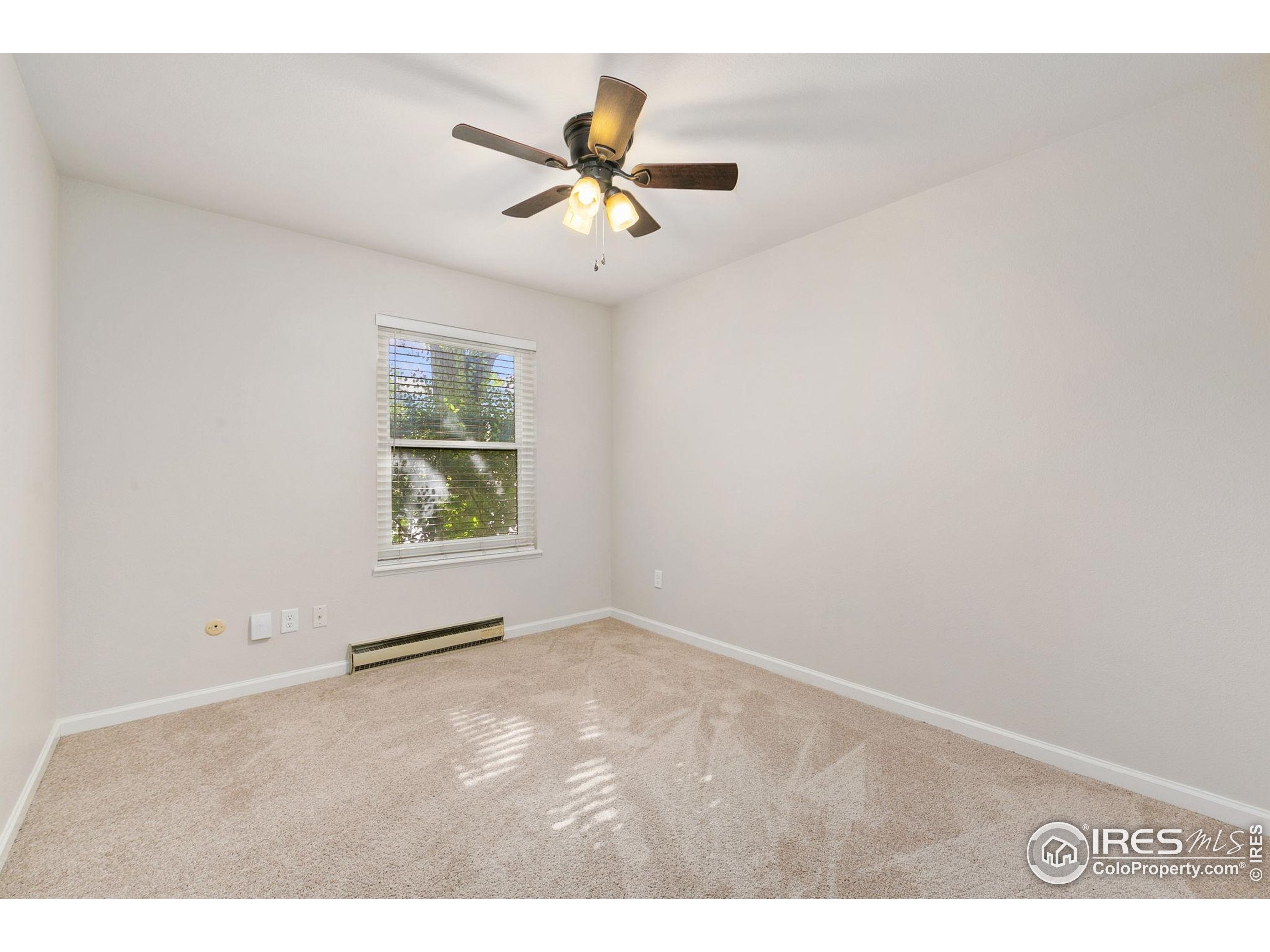 1741 Brookhaven Circle East, Unit D Fort Collins, CO 80525 - Photo 21 of 30 a view of an empty room with a window