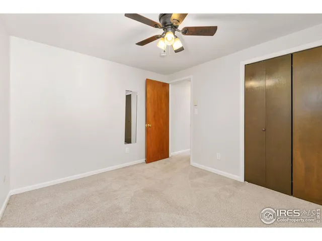 a view of an empty room with a ceiling fan