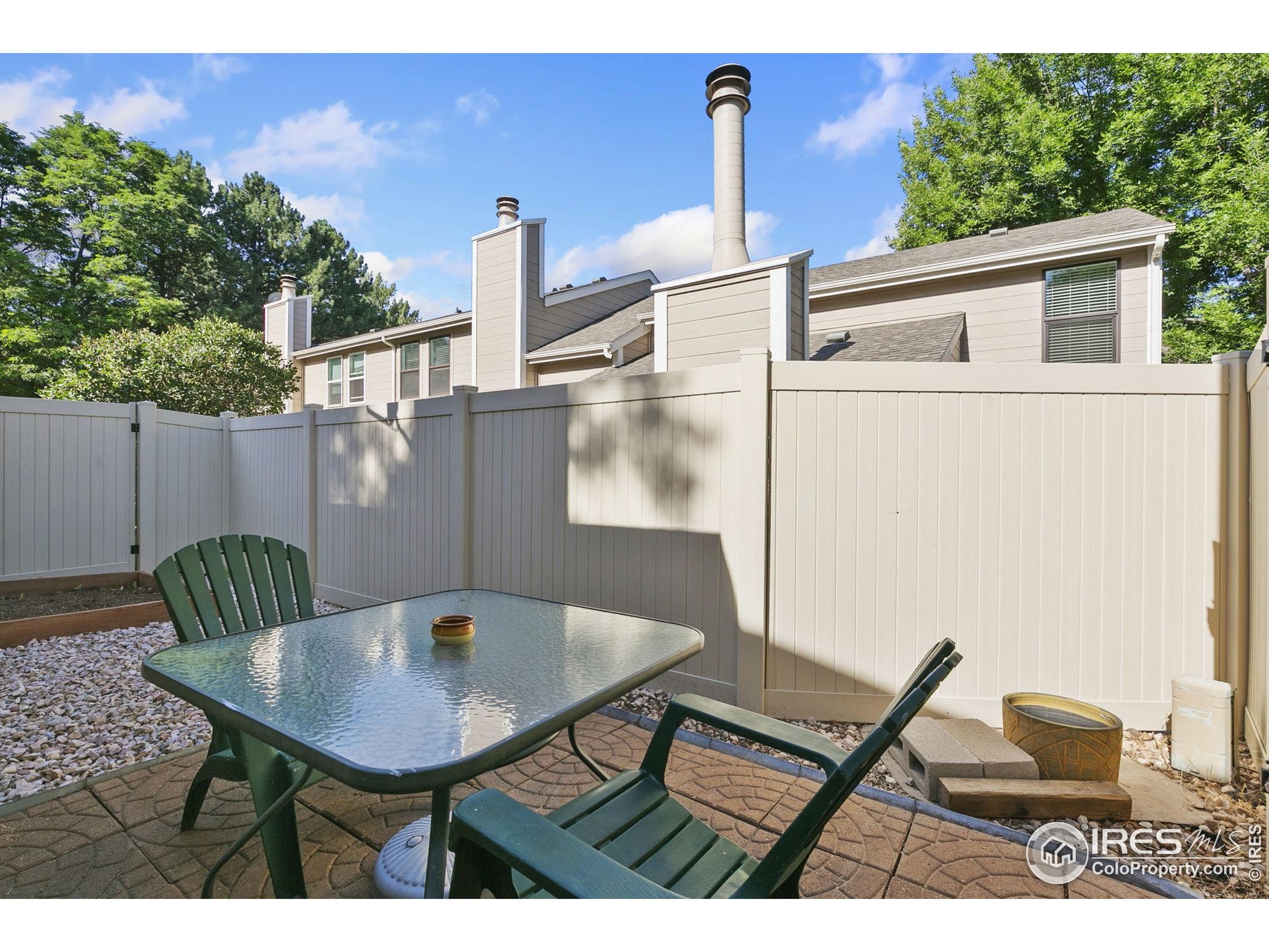 1741 Brookhaven Circle East, Unit D Fort Collins, CO 80525 - Photo 28 of 30 a backyard of a house with table and chairs