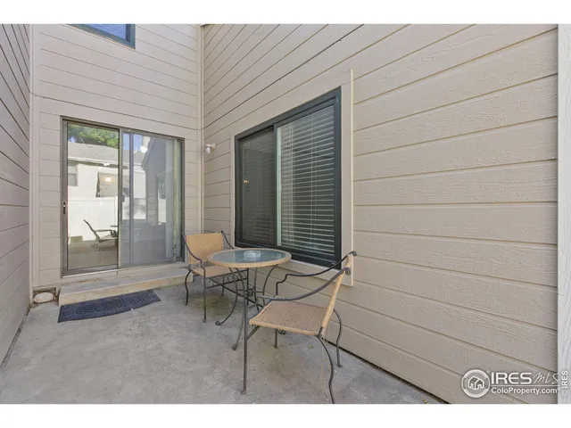 a balcony with table and chairs