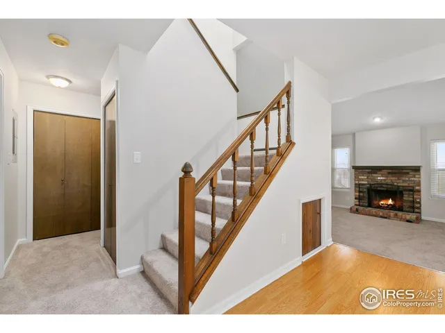 a view of a livingroom with wooden floor and furniture