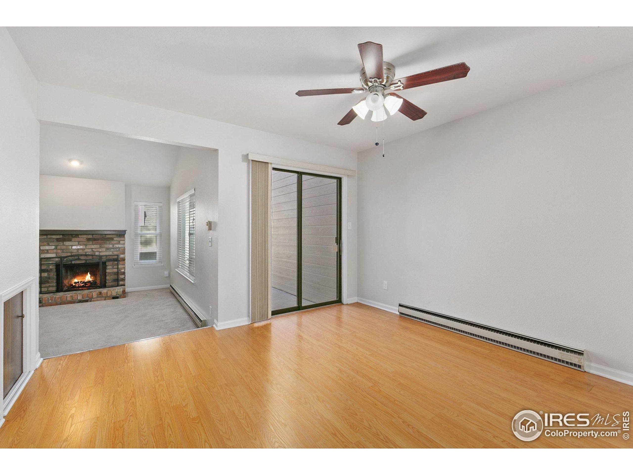 1741 Brookhaven Circle East, Unit D Fort Collins, CO 80525 - Photo 4 of 30 a view of an empty room and kitchen with fireplace
