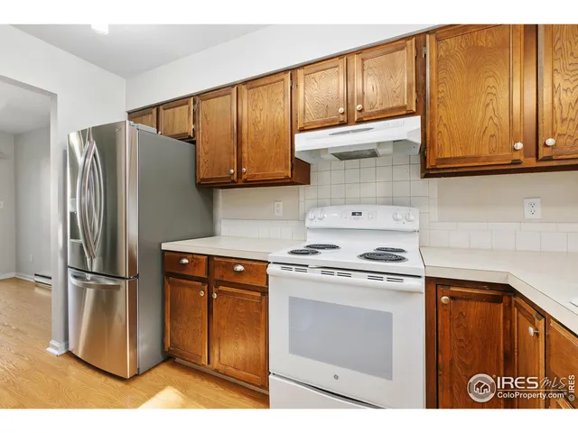 a kitchen with stainless steel appliances granite countertop a refrigerator stove and sink