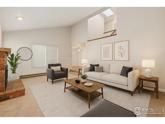 a living room with furniture a rug and a potted plant