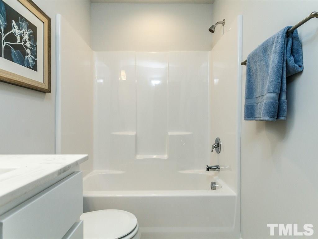 3340 Tracer Drive Graham, NC 27253 - Photo 17 of 23 a bathroom with a shower a toilet and a bathtub