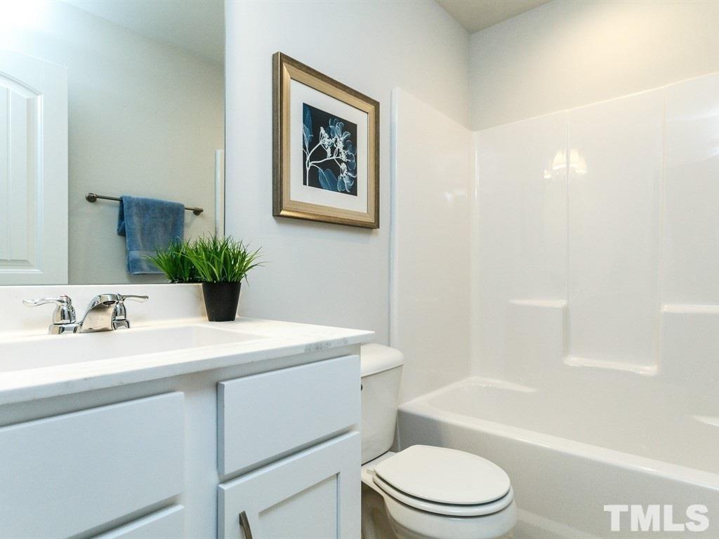 3340 Tracer Drive Graham, NC 27253 - Photo 19 of 23 a bathroom with a sink a toilet and shower