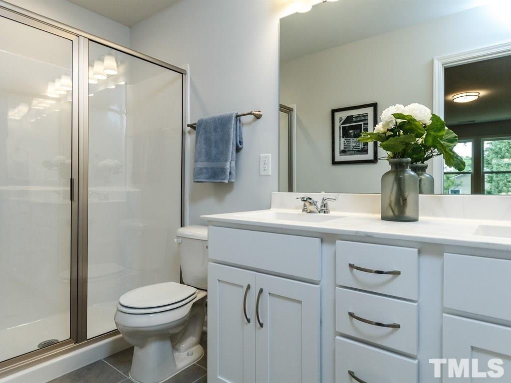 3340 Tracer Drive Graham, NC 27253 - Photo 23 of 23 a bathroom with a sink a toilet and shower