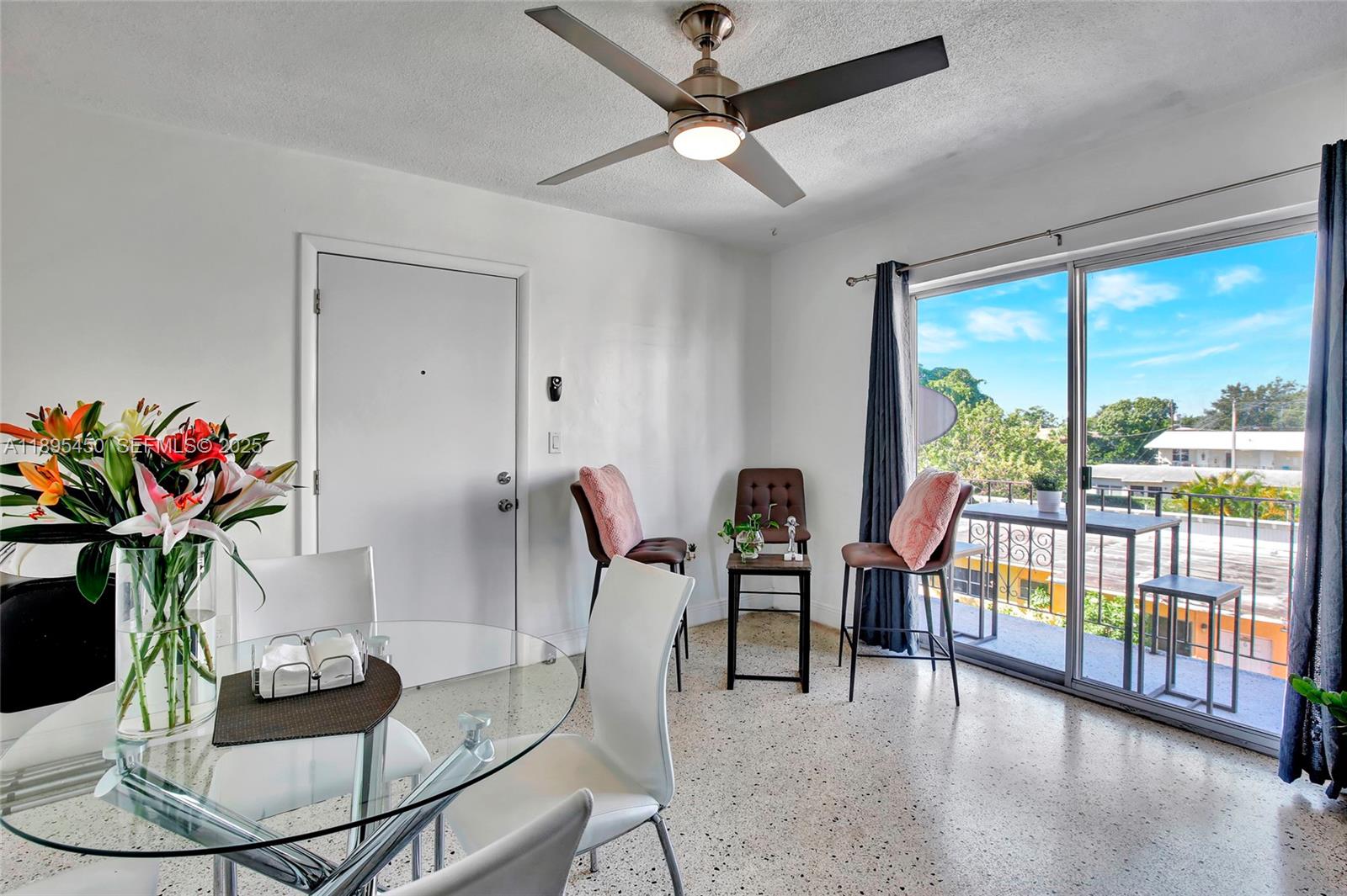 a dining room with furniture potted plants and wooden floor