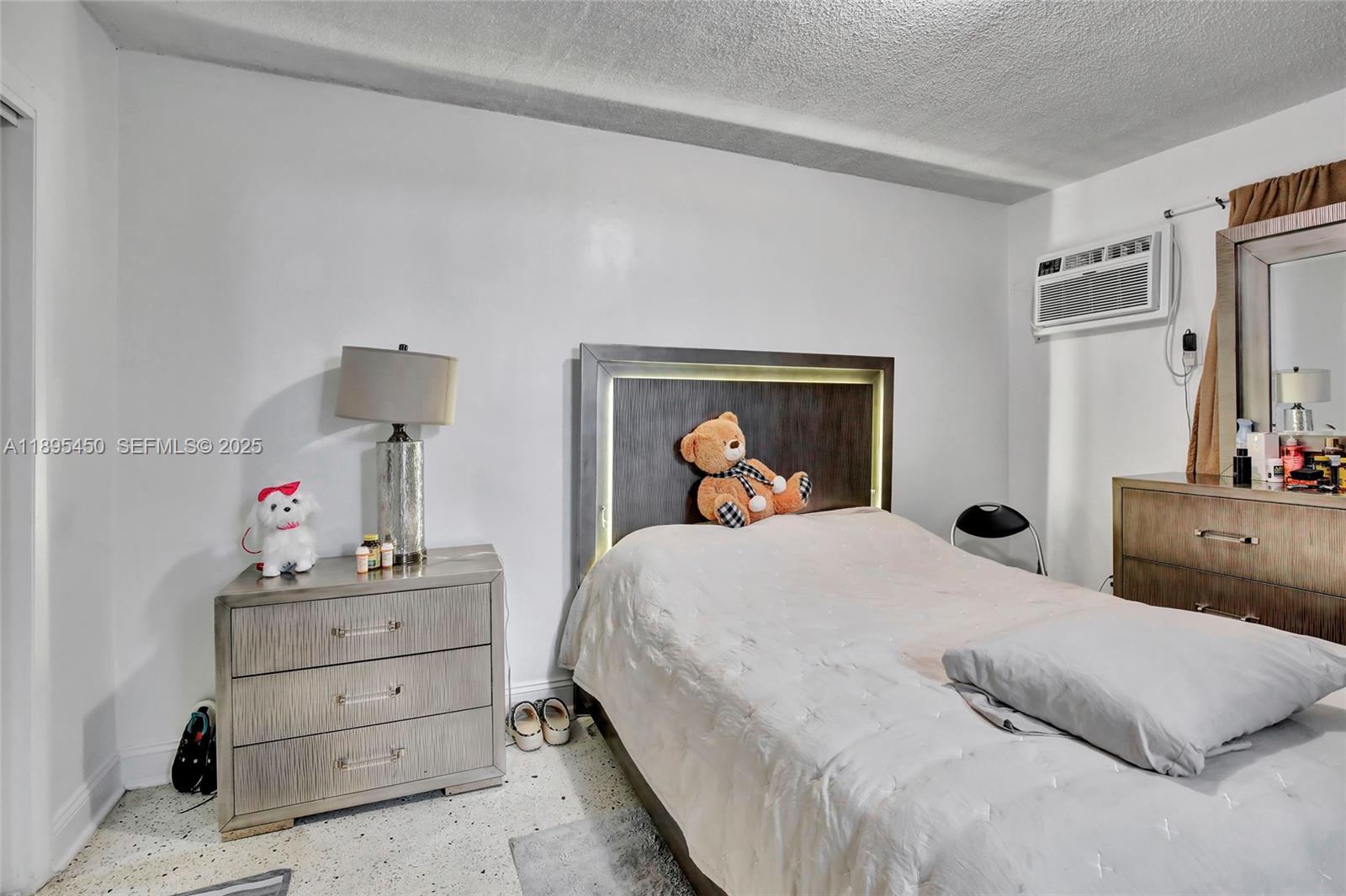 458 Southwest 9th Street, Unit 8 Miami, FL 33130 - Photo 15 of 22 a bedroom with a bed and a lamp on dresser