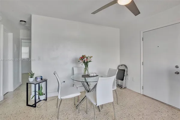 a dining room with furniture and potted plants