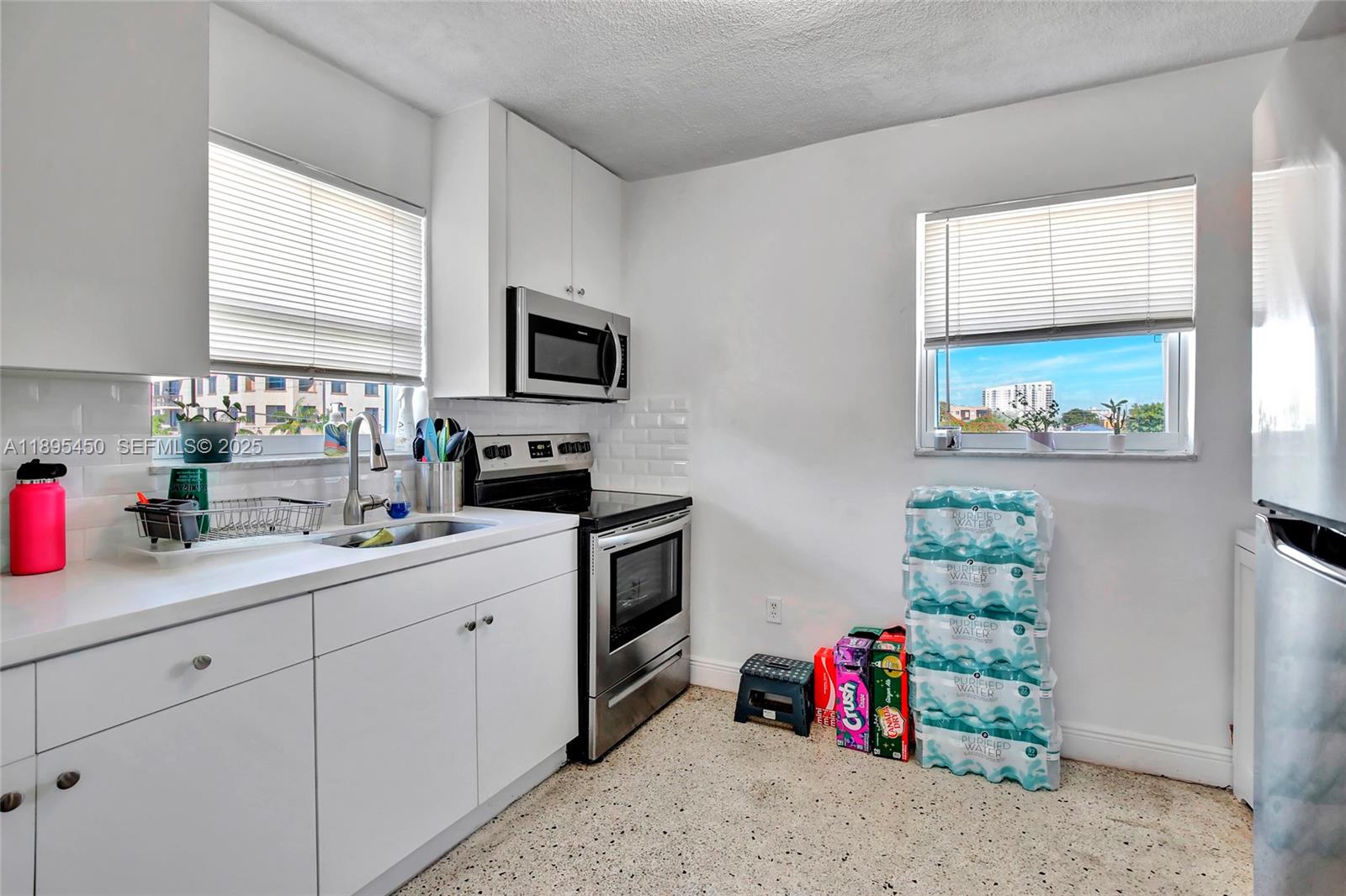 458 Southwest 9th Street, Unit 8 Miami, FL 33130 - Photo 8 of 22 a bathroom with a sink mirror and window