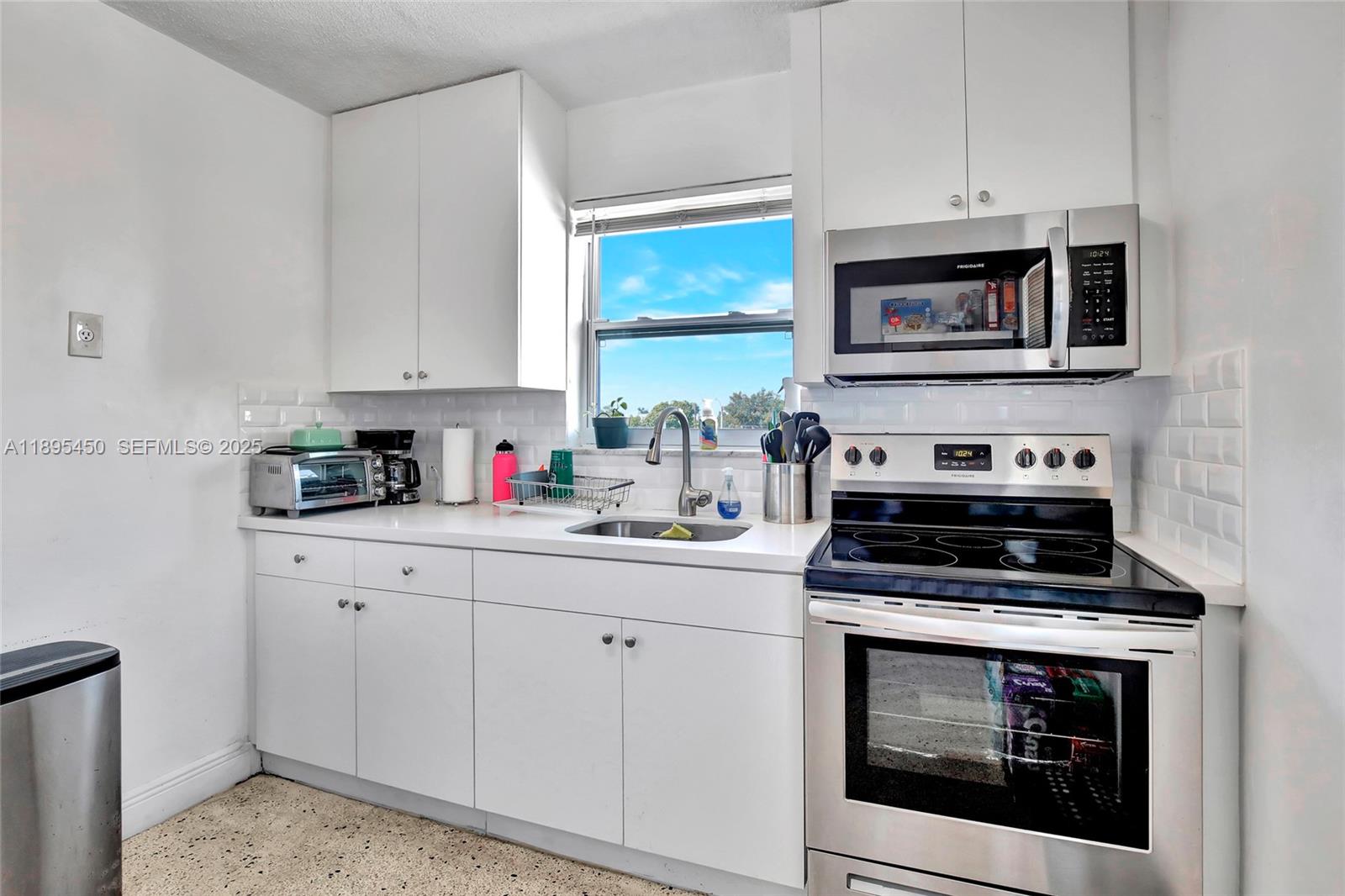 458 Southwest 9th Street, Unit 8 Miami, FL 33130 - Photo 9 of 22 a kitchen with white cabinets and appliances