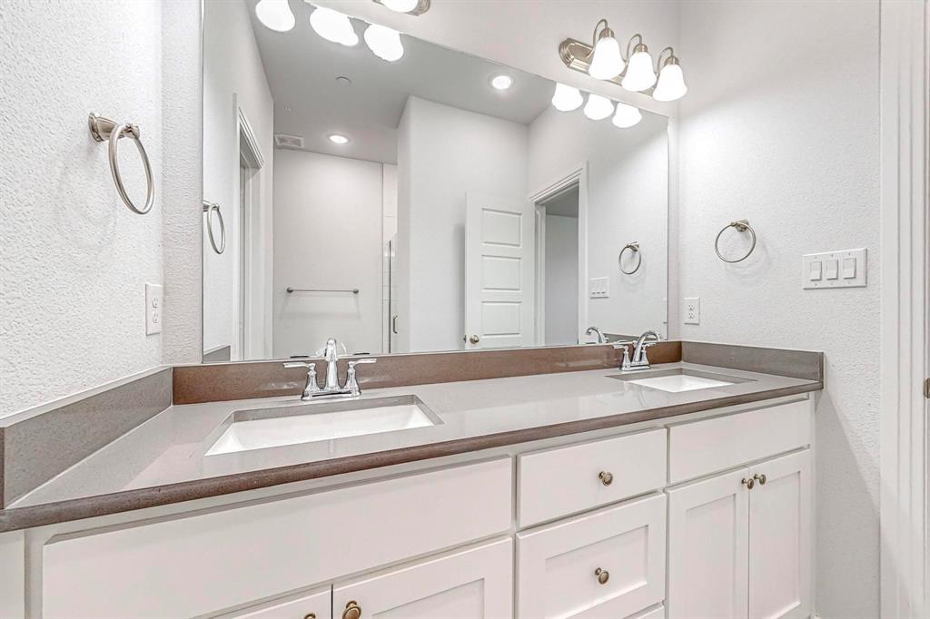 265 Buck Ridge Drive Frisco, TX 75068 - Photo 25 of 40 a bathroom with a sink vanity and a mirror