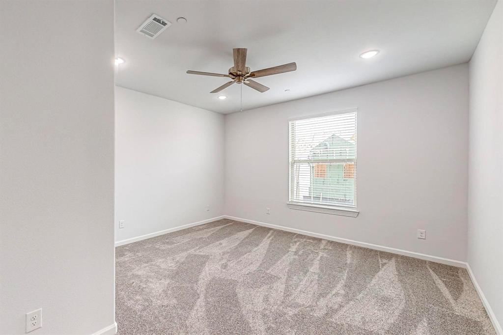 265 Buck Ridge Drive Frisco, TX 75068 - Photo 32 of 40 an empty room with a window and ceiling fan