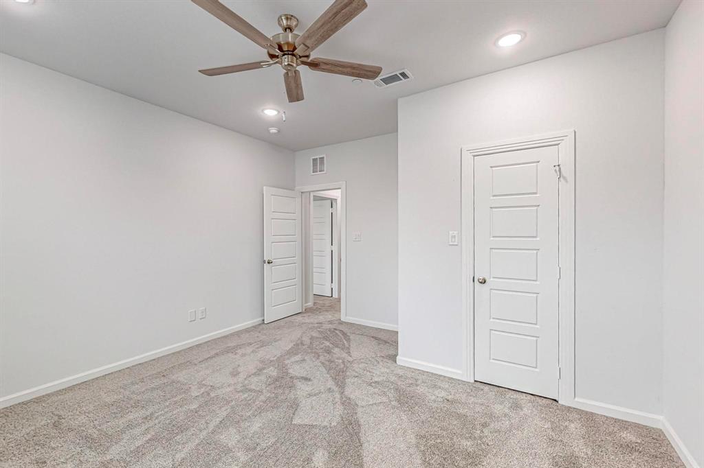 265 Buck Ridge Drive Frisco, TX 75068 - Photo 34 of 40 an empty room with fan and a ceiling fan