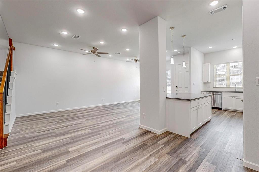 265 Buck Ridge Drive Frisco, TX 75068 - Photo 10 of 40 a large white kitchen with a white countertops a sink and a stove