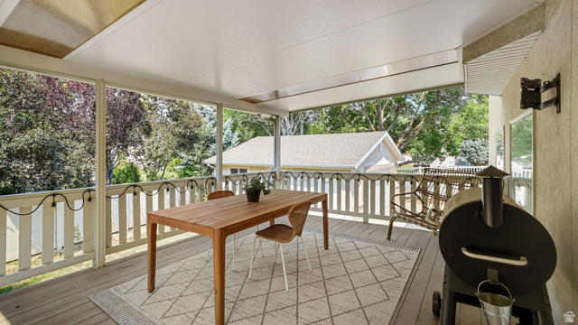 11128 South Barrett Pk Circle Sandy, UT 84092 - Photo 11 of 36 Expansive covered deck featuring wood-finish flooring, a white railing, and a slatted ceiling