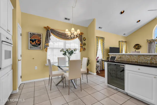 a view of a kitchen area with furniture and chandelier