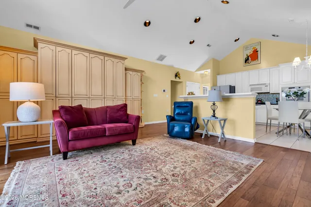 a living room with furniture and a wooden floor