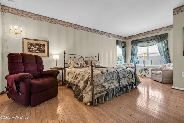 a bedroom with bed couch and window