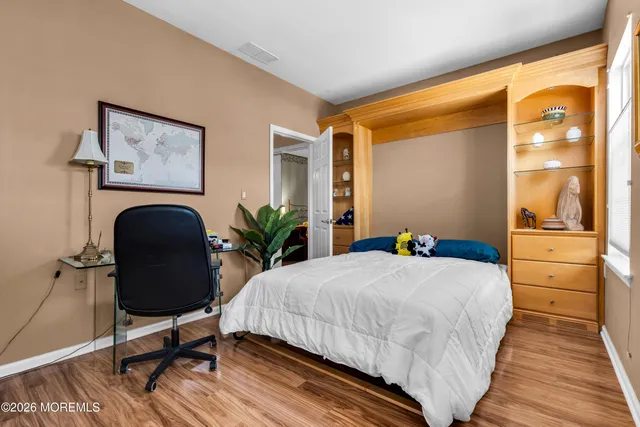 a bedroom with a bed and a potted plant