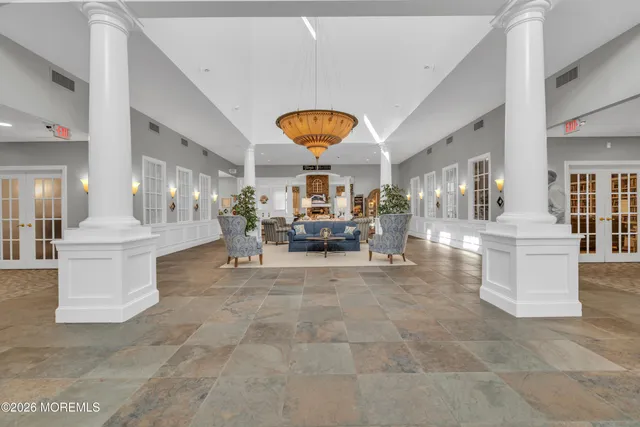 a living room with couches and kitchen view
