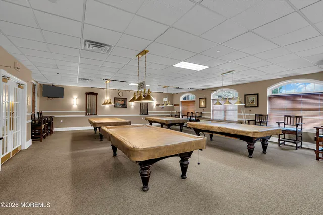 a living room with pool table and a table