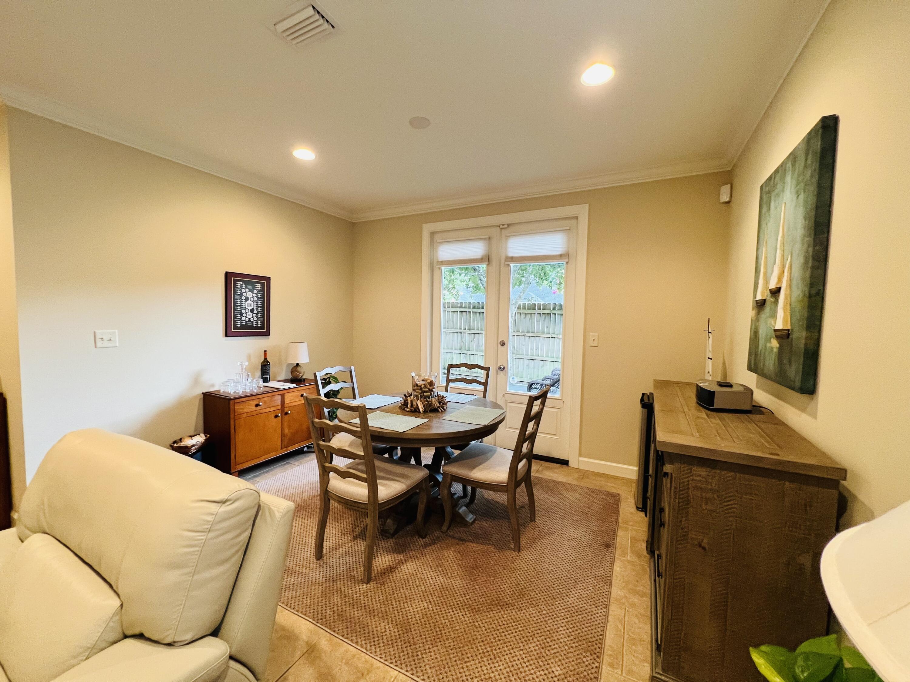 4248 Skipjack Cove Niceville, FL 32578 - Photo 12 of 64 a living room with furniture a large window and a dining table