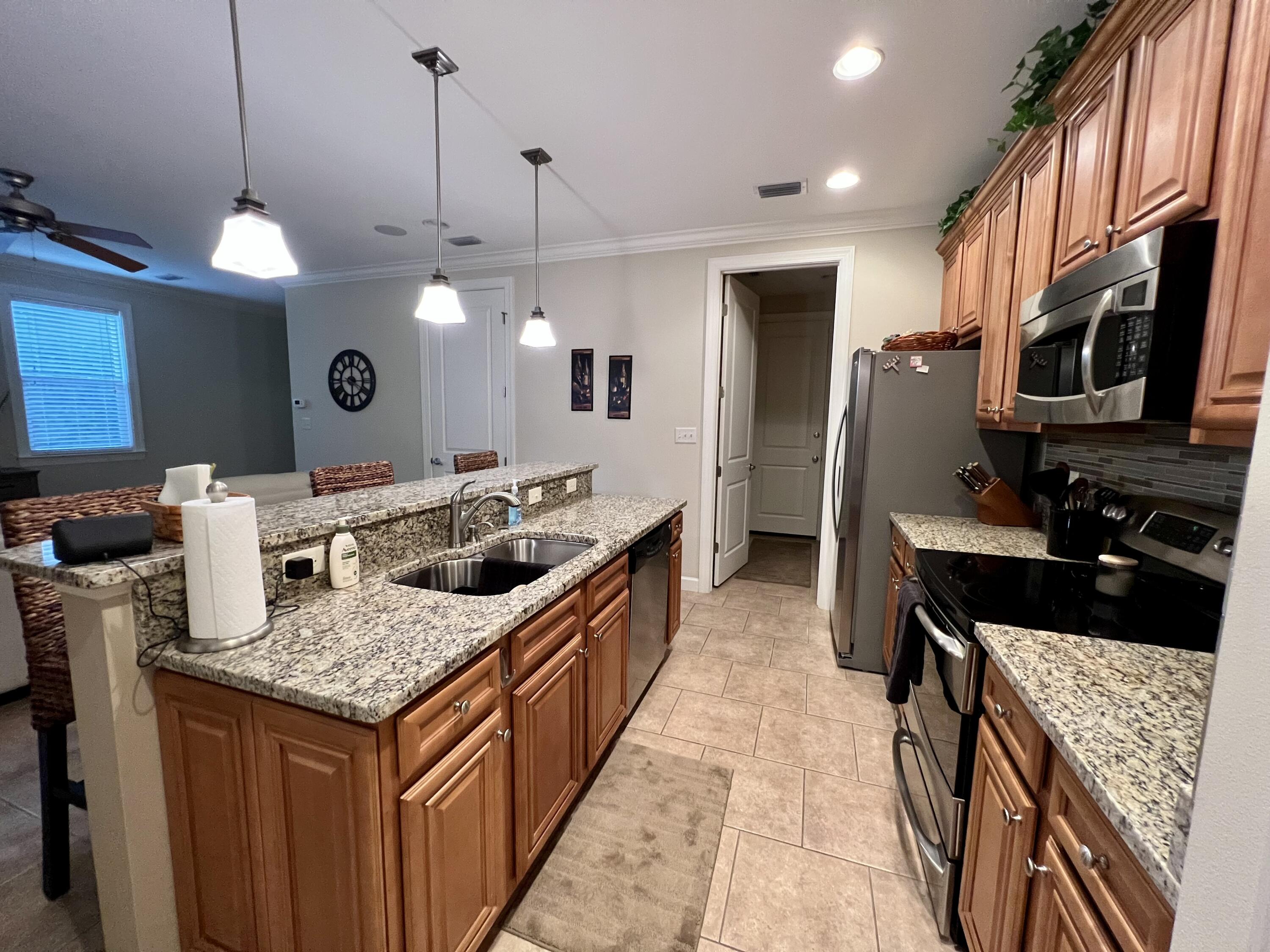 4248 Skipjack Cove Niceville, FL 32578 - Photo 18 of 64 a kitchen with stainless steel appliances granite countertop a stove a sink and a refrigerator