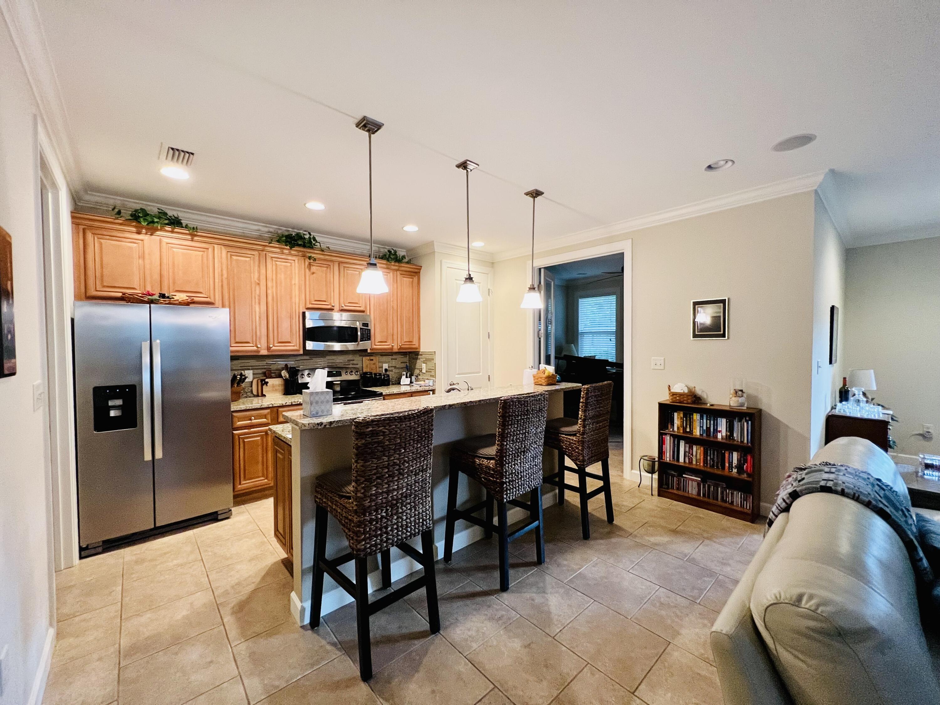 4248 Skipjack Cove Niceville, FL 32578 - Photo 21 of 64 a kitchen with a refrigerator a oven a sink a dining table and chairs